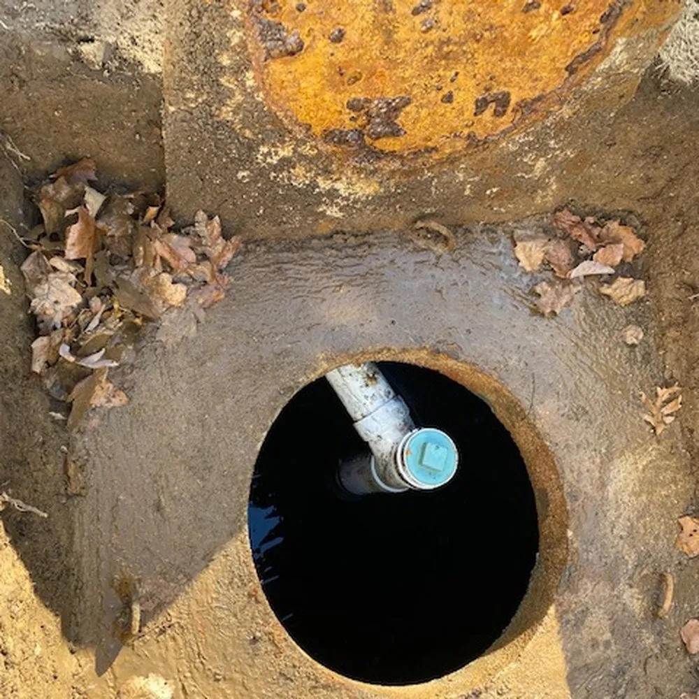 Septic tank interior with the inlet baffle exposed during an inspection at a Haines City, FL home
